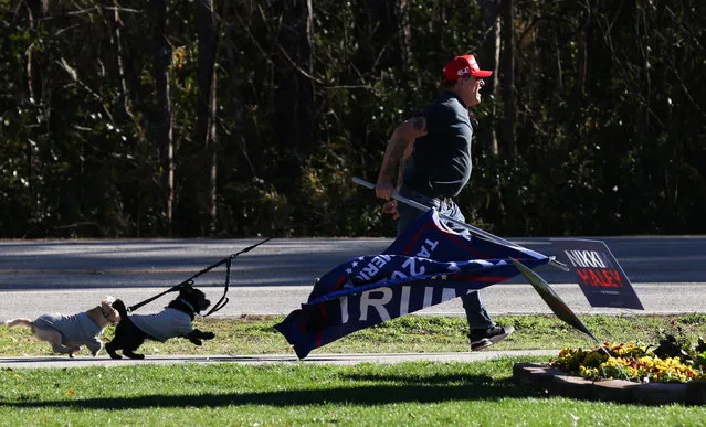 Thaddeus Sikorski, of Charleston, chases after after someone stealing Donald Trump signs before a rally for Republican presidential candidate Nikki Haley at Coastal Carolina University on Sunday, January 28, 2024 in Conway, S.C. The South Carolina Republican presidential primary is being held February 24. (Photo by Sam Wolfe for The Washington Post)