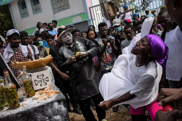 Voodoo followers, called Pitit Fey, attend a ceremony during the Day of the Dead celebrations at the Meyotte cemetery in Kay Gouye, in Port-au-Prince, Haiti, November 1, 2021. (Photo by Claudia Daut/Reuters)
