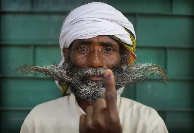 An Indian displays indelible ink mark on his index finger after casting his vote in the seventh and final phase of national elections, on the outskirts of Varanasi, India, Sunday, May 19, 2019. (Photo by Rajesh Kumar Singh/AP Photo)