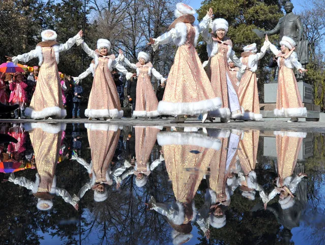 Kyrgyz actors, wearing their traditional costumes, sing and dance during the festivities of Maslenitsa on February 26, 2017 in the Kyrgyzstan's capital Bishkek. “Maslenitsa” or Shrovetide, also known as the Butter Week, the Pancake week, or the Cheesefare Week, is a Russian religious and folk holiday. It is celebrated during the last week before Great Lent – that is, the seventh week before Easter. Maslenitsa corresponds to the Western Christian Carnival. (Photo by Vaycheslav Oseledko/AFP Photo)