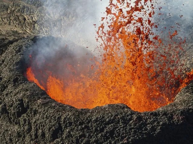 Lava erupt near the town of Grindavik, Iceland, Thursday, March 28, 2024. (Phoot by Marco di Marco/AP Photo)