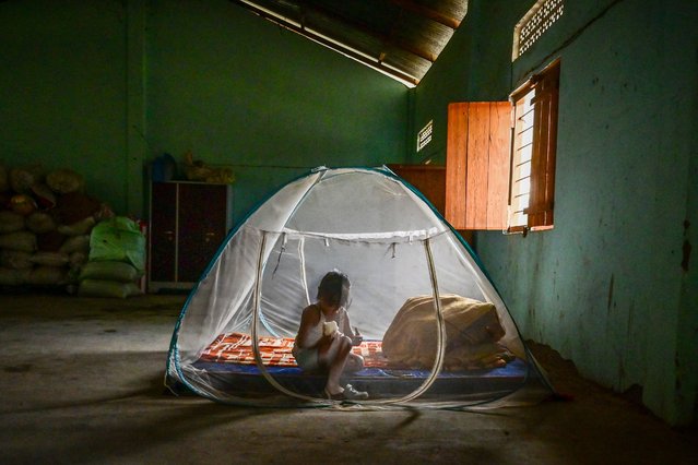 A child Kuki ethnic group sits inside a tent at a relief camp for internally displaced people on April 27, 2024 in Litan village, Manipur, India. Simmering tensions between the Kukis and Meitis have reached a critical juncture, casting a shadow over the region's delicate social fabric in India's eastern Manipur state. As historical grievances resurface, ethnic violence has forced large numbers of both groups to become displaced and seek shelter in government-run camps. (Photo by Ritesh Shukla/Getty Images)