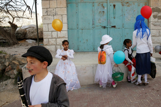 People dressed in costumes take part in a parade marking the Jewish holiday of Purim, a celebration of the Jews' salvation from genocide in ancient Persia, as recounted in the Book of Esther, in the West Bank city of Hebron March 12, 2017. (Photo by Baz Ratner/Reuters)