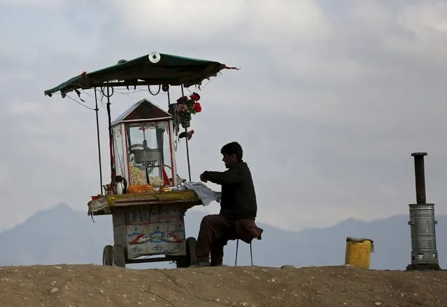 An Afghan man sells popcorn in Kabul March 31, 2016. (Photo by Ahmad Masood/Reuters)