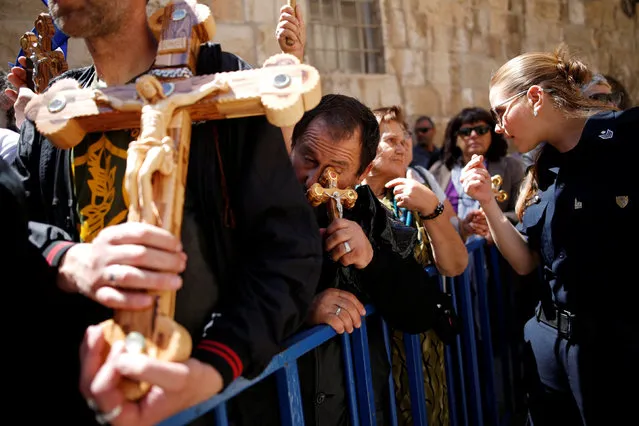 Orthodox Christian worshipers take part in a procession along the Via Dolorosa on Good Friday, during Holy Week in Jerusalem's Old City, April 29, 2016. (Photo by Amir Cohen/Reuters)