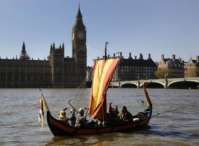 Members of a re-enactment group dressed as Vikings sail a replica Viking longboat past the Houses of Parliament in London, on April 15, 2014. The exhibition “Vikings: Life and Legend” is showing at the British Museum, and a live broadcast of the exhibition will be shown in 400 cinemas across Britain on April 24. (Photo by Luke Macgregor/Reuters)