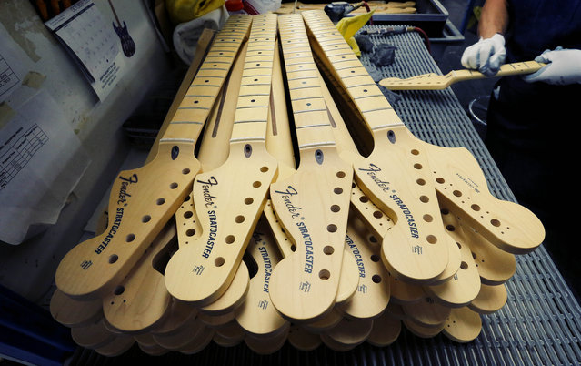 Fender Stratocaster necks are prepared for assembly at the Fender factory in Corona, Calif. on Tuesday, October 15, 2013. (Photo by Matt York/AP Photo)