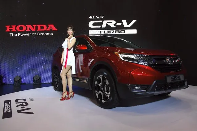 A South Korean model poses with Honda's All New CR-V Turbo during a press preview of the Seoul Motor Show in Goyang, northwest of Seoul, on March 30, 2017. (Photo by Jung Yeon-Je/AFP Photo)