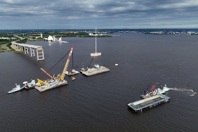 In an aerial view, a construction barge moves past other salvage crews as they continue to clean up the wreckage from the collapse of the Francis Scott Key Bridge in the Patapsco River on June 11, 2024 in Baltimore, Maryland. Baltimore's Fort McHenry Federal Channel has fully opened for shipping traffic months after the cargo ship Dali collided with the bridge, causing it to collapse. (Photo by Kevin Dietsch/Getty Images)