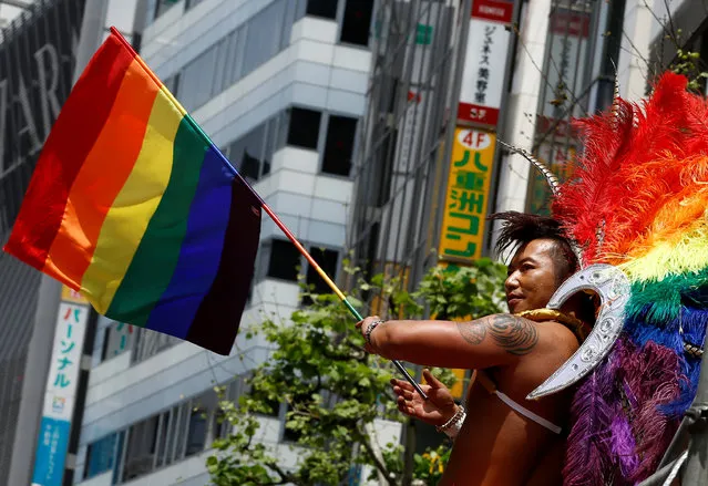 A reveller holds a rainbow flag during the Tokyo Rainbow Pride parade celebrating lesbian, gay, bisexual, and transgender (LGBT) culture in Tokyo, Japan, May 8, 2016. (Photo by Thomas Peter/Reuters)