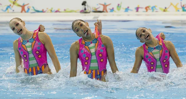 Members of Mexico's synchronised swimming team perform a clown inspired number for their free routine at the Pan Am Games in Toronto, Saturday, July 11, 2015. (Photo by Rebecca Blackwell/AP Photo)