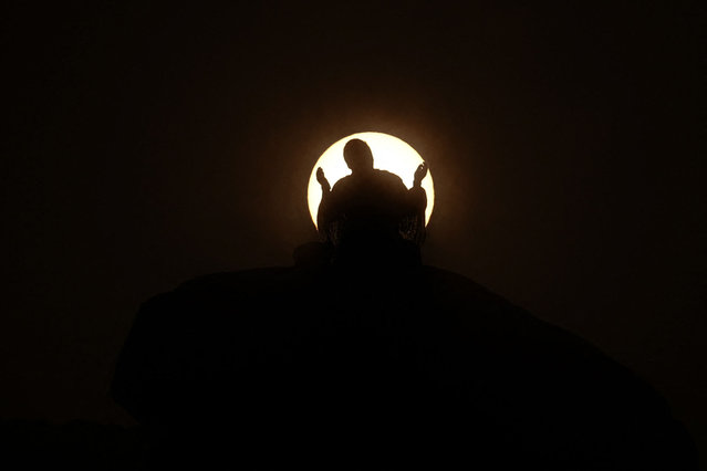 Muslim pilgrims pray at dawn on Saudi Arabia's Mount Arafat, also known as Jabal al-Rahma or Mount of Mercy, during the climax of the Hajj pilgrimage on June 15, 2024. More than 1.5 million Muslims will pray on Mount Arafat in soaring temperatures on June 15, in the high-point and most gruelling day of the annual Hajj pilgrimage, one of the five pillars of Islam that must be performed at least once by all Muslims who have the means to do so. (Photo by Fadel Senna/AFP Photo)