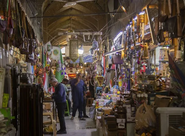 People shop in Al Sarai antiques market in Baghdad, Iraq, Saturday, February 19, 2022. (Photo by Hadi Mizban/AP Photo)