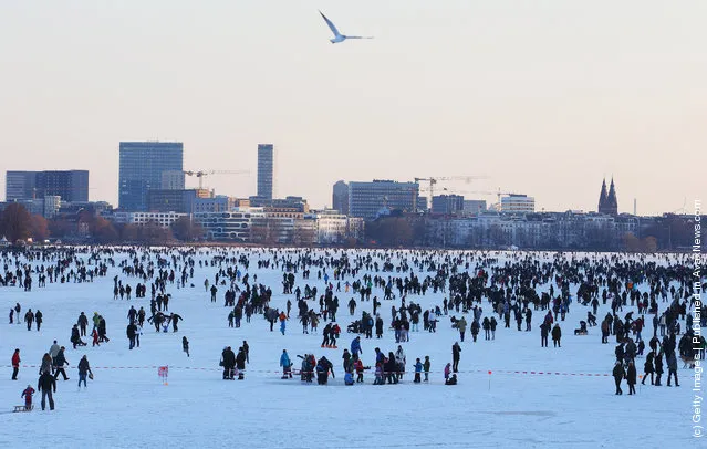Thousands of people stay on the frozen Aussenalster river during the 'Alstervergnuegen' on February