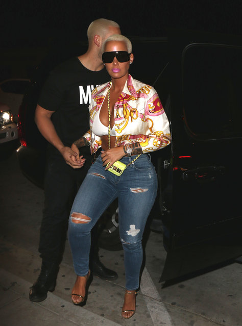 Amber Rose arrives at Catch restaurant wearing ripped denim, bright print silk blouse and dark sunglasses. Los Angeles, California on Friday, April 28, 2017. (Photo by MHD/PacificCoastNews)