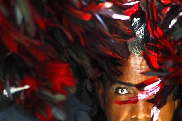 A reveler takes part in the Gay Pride march in Caracas, Venezuela, July 7, 2024. (Photo by Cristian Hernandez/AP Photo)