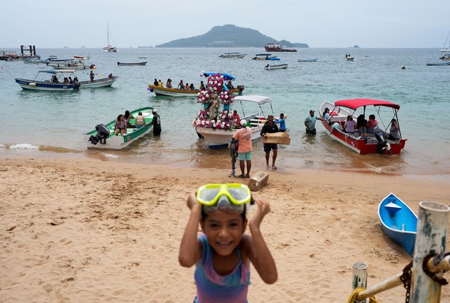 Fishermen prepare their boats to attend an ocean procession honouring the Virgen del Carmen in Taboga island, near Panama City on 16, 2024. Every July 16, Fishermen attend an ocean procession honouring the day of the Virgen del Carmen which Catholics consider as the patron saint of fishermen and sailors. (Photo by Arnulfo Franco/AFP Photo)