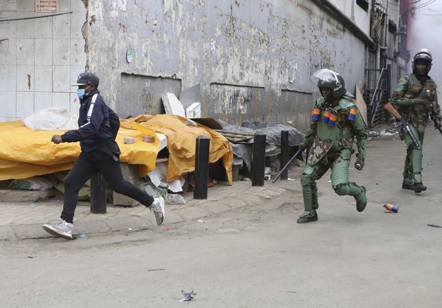 A protestor is chased by police in Nairobi, Kenya, Thursday August 8, 2024. (Photo by Andrew Kasuku/AP Photo)