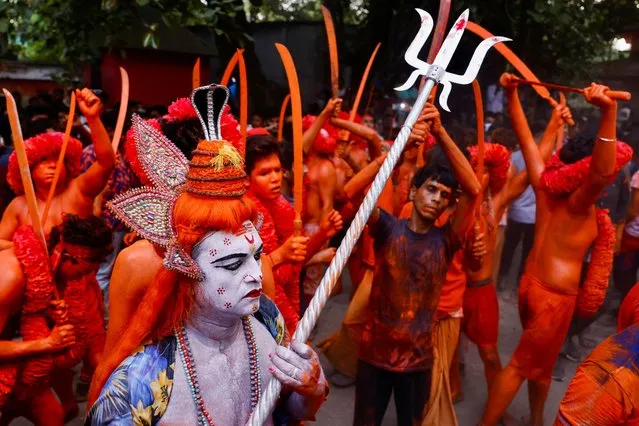 Hindu devotees dance after applying paints on their bodies as they celebrate the Lal Kach festival in Munshiganj, Bangladesh, April 13, 2022. (Photo by Mohammad Ponir Hossain/Reuters)