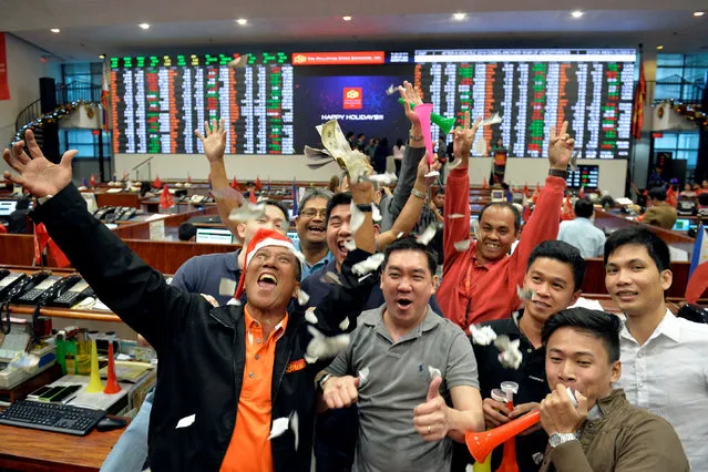 Traders throw confetti as they celebrate the end of trading for year 2016 at the Philippine Stock Exchange in Makati, Metro Manila, Philippines December 29, 2016. (Photo by Ezra Acayan/Reuters)