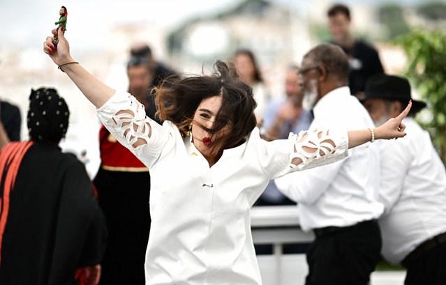 Moroccan director Asmae El Moudir poses with cast members during a photocall for the film “Kadib Abyad” (The Mother of All Lies) at the 76th edition of the Cannes Film Festival in Cannes, southern France, on May 25, 2023. (Photo by Loïc Venance/AFP Photo)