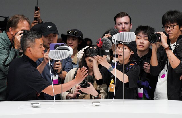 People use cameras as Apple's Vision Pro headsets are on display at Apple's annual Worldwide Developers Conference at the company's headquarters in Cupertino, California, U.S. June 5, 2023. (Photo by Loren Elliott/Reuters)