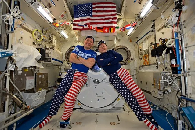 NASA astronauts Jack Fischer and Peggy Whitson celebrate the Fourth of July from over 250 miles above Earth on the International Space Station, Tuesday, July 4, 2017. Fischer shared this photo on social media and said, “We sometimes have issues standing up straight, but we have no problems at all showing our American pride-Happy 4th!”. (Photo by NASA)