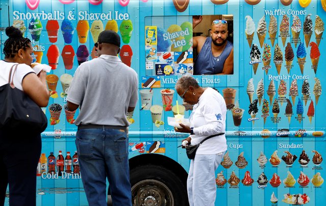 People stand in front of a foodtruck in Washington, DC, U.S., September 20, 2024. (Photo by Piroschka van de Wouw/Reuters)