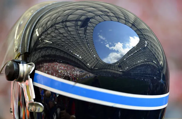 The stadium is reflected on a riot police's helmet before the UEFA EURO 2016 group F preliminary round match between Iceland and Hungary at Stade Velodrome in Marseille, France, June 18, 2016. (Photo by Tibor Illyes/EPA)