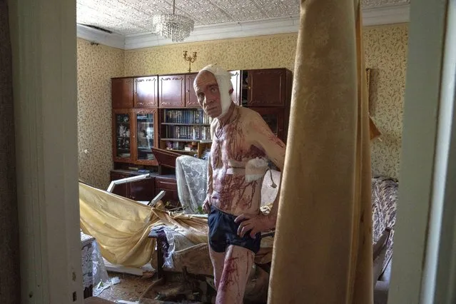66-year-old Volodymyr, injured from a strike, looks at damages in his apartment, in Kramatorsk, Donetsk region, eastern Ukraine, Thursday, July 7, 2022. (Photo by Nariman El-Mofty/AP Photo)