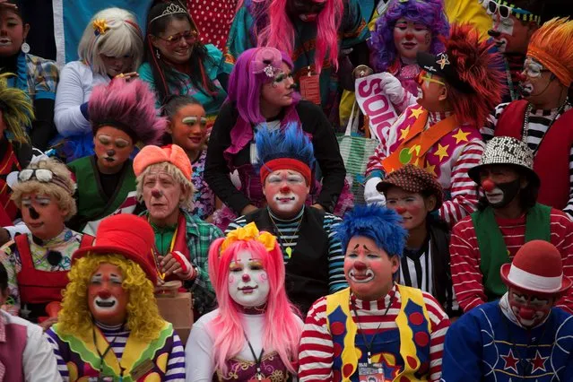 Clowns gather for a group picture during the sixth annual Latin American Clown Congress in Guatemala City, Tuesday, July 29, 2014. Clowns from Central America and North America have gathered for four days in the capital city to exchange ideas and attend workshops. (Photo by Moises Castillo/AP Photo)