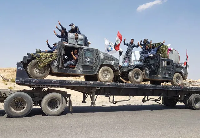 A handout picture released by the Iraqi Federal Police on August 15, 2017, shows Iraqi armoured units headed for the town of Tal Afar, the main remaining Islamic State (IS) group stronghold in the northern part of the country.
Iraqi warplanes carried out air strikes against IS group positions in Tal Afar in preparation for a ground assault to retake the town near the Syrian border, the military said. (Photo by AFP Photo/Iraqi Federal Police)