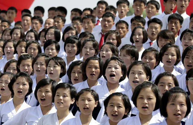 A North Korean student choir sing as part of the celebrations for the anniversary of the Korean War armistice agreement, Sunday, July 27, 2014, in Pyongyang, North Korea. North Koreans gathered at Kim Il Sung Square as part of celebrations for the 61st anniversary of the armistice that ended the Korean War. (Photo by Wong Maye-E/AP Photo)