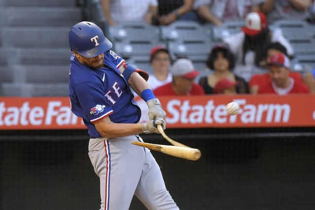 Texas Rangers' Nick Solak breaks his bat as he hits a single during the third inning of a baseball game against the Los Angeles Angels Friday, July 29, 2022, in Anaheim, Calif. (Photo by Mark J. Terrill/AP Photo)