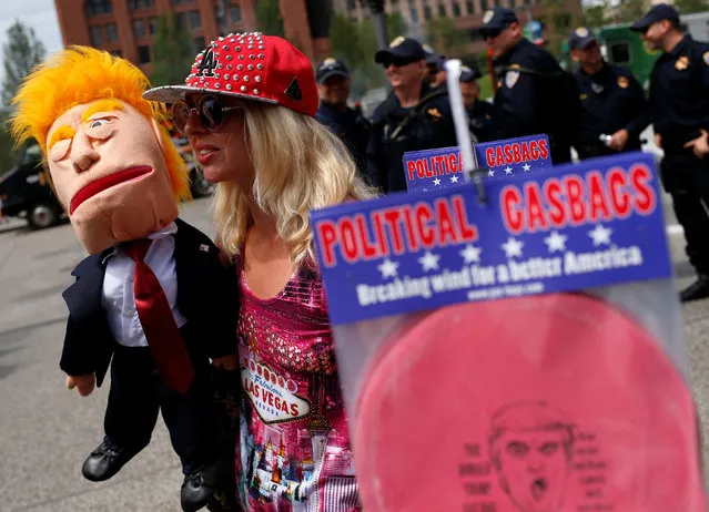 April Brucker, with the gourd stand against Trump, holds a Donald Trump puppet in public square outside the Republican National Convention in Cleveland, Ohio, U.S. July 18, 2016. (Photo by Shannon Stapleton/Reuters)