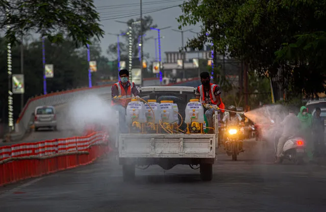 Indian municipal workers spray disinfectants as a preventive measure against the spread of the new coronavirus on a street in Gauhati, India, Wednesday, March 25, 2020. (Photo by Anupam Nath/AP Photo)