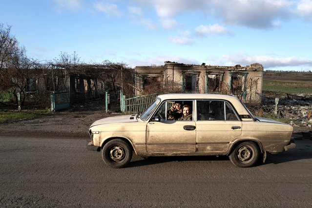 Ukranian soldiers drive past a house destroyed by shelling in the city of Konstantinopil, in the Donetsk region, on November 16, 2024. The Kremlin accused US President Joe Biden on November 18, 2024 of escalating the war in Ukraine by allowing Kyiv to use long-range missiles supplied by Washington to strike targets inside Russia. (Photo by Florent Vergnes/AFP Photo)