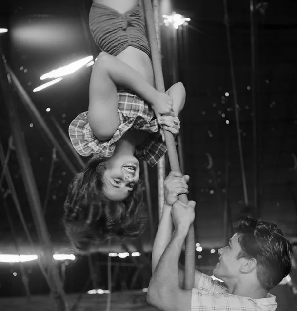 An acrobat rehearsing for the Ringling Bros. and Barnum & Bailey Circus while an unidentified man holding a rope in Sarasota in 1949. (Photo By Nina Leen/Time Life Pictures/Getty Images)