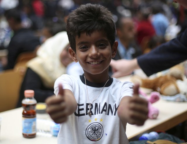 A migrant  boy gives thumbs-up in a registration centre at the main railway station in Dortmund, Germany September 6, 2015. (Photo by Ina Fassbender/Reuters)