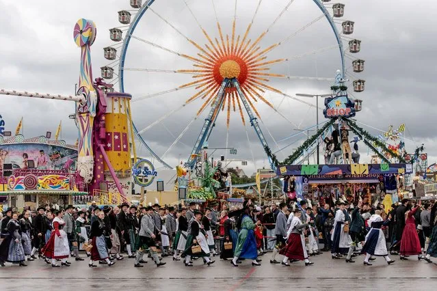 People in traditional clothing participate in the costume parade during the 187th edition of the traditional Oktoberfest beer and amusement festival in the German Bavaria state's capital of Munich, Germany, 18 September 2022. The Oktoberfest 2022 runs from 17 September to 03 October 2022 and several millions of visitors are expected from all over the world. The event resumes after being canceled for two years in a row due to the coronavirus disease (COVID-19) pandemic. (Photo by Christian Bruna/EPA/EFE)