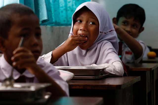 Students eat meals from the free nutritious meals program at a school in Jakarta, Indonesia on January 6, 2025. (Photo by Willy Kurniawan/Reuters)