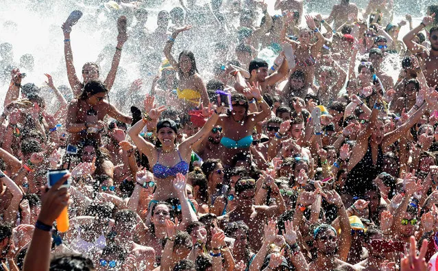 People dance in a pool as they attend the Arenal Sound music Festival held on Burriana beach on August 6, 2016. Arenal sound Festival is a 5 day music festival with 240,000 people on the east coast of Spain between Valencia and Castellon. (Photo by Jose Jordan/AFP Photo)