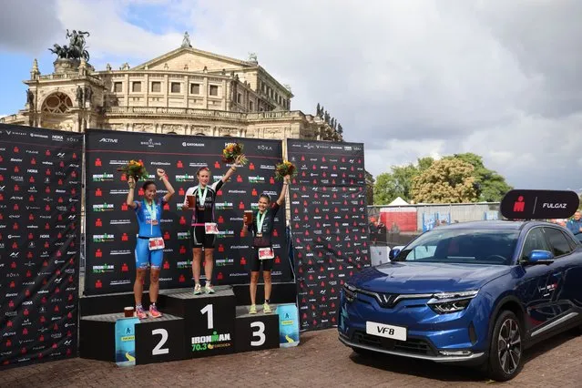 Image has been digitally enhanced) Caroline Pohle of Germany (C), Nikki Bartlett (L) of Great Britain and Daniela Kleiser of Germany celebrate after winning the IRONMAN 70.3 Dresden on September 18, 2022 in Dresden, Germany. (Photo by Joern Pollex/Getty Images for IRONMAN)