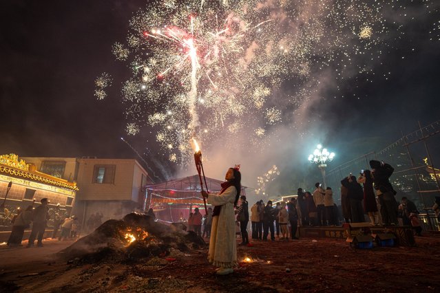 Citizens, holding torches, walk on the streets during the Torch Festival in Jieyang, China on February 4, 2025.Villagers commemorate their ancestors in the form of the Torch Festival, which is held during the Spring Festival and has a history of over 300 years. During the festival, villagers hold torches and take to the streets with firecrackers and fireworks. (Photo by John Ricky/Anadolu via Getty Images)