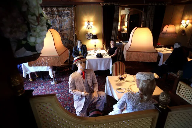 Mannequins costumed in 1940s era clothing are seated in the dining area of the Inn at Little Washington, a Michelin three star restaurant in the Virginia countryside, in Rappahannock County May 14, 2020 in Washington, Virginia. Due to the COVID-19 pandemic, the Commonwealth of Virginia will allow restaurants to reopen at only 50 percent capacity to maintain social distancing. However, the chef at the restaurant, Patrick OConnell, plans to keep the mannequins in place when the business reopens on May 29 rather than let the tables sit vacant when diners return. (Photo by Win McNamee/Getty Images)