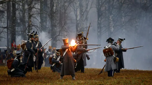 People dressed in the historic uniforms of the French army take part in a re-enactment of the 1812 Battle of Berezina, to mark the 205th anniversary of the battle, near the village of Bryli, Belarus on November 26, 2017. (Photo by Vasily Fedosenko/Reuters)