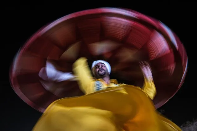 An Egyptian tradional dancer performs the “Tanoura” dance during a street performance in Sharm El-Sheikh, Egypt, 06 November 2022. (Photo by Sedat Suna/EPA/EFE)