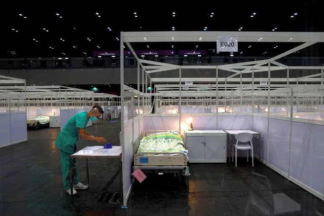 Rows of beds are seen at a temporary field hospital set up at Asia World Expo in Hong Kong, Saturday, August 1, 2020. The new Covid-19 patient holding facility can accommodate up to 500 adult patients in stable conditions. The facility which is located near the Hong Kong International Airport is a big convention and exhibition facility and was previously used as a coronavirus testing center for incoming travelers. It's transformed into a treatment facility so that it helps freeing up hospital beds for the serious patients. (Photo by Kin Cheung/AP Photo)