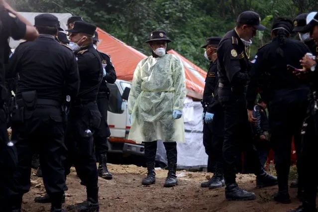 A policeman looks on as he takes a break near an area affected by a mudslide in Santa Catarina Pinula, on the outskirts of Guatemala City, October 4, 2015. (Photo by Josue Decavele/Reuters)
