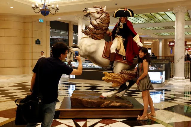 A visitor poses in front of an artist impersonating French Emperor Nepoleon I inside Parisian Macao as part of the Las Vegas Sands development in Macau, China September 13, 2016. (Photo by Bobby Yip/Reuters)